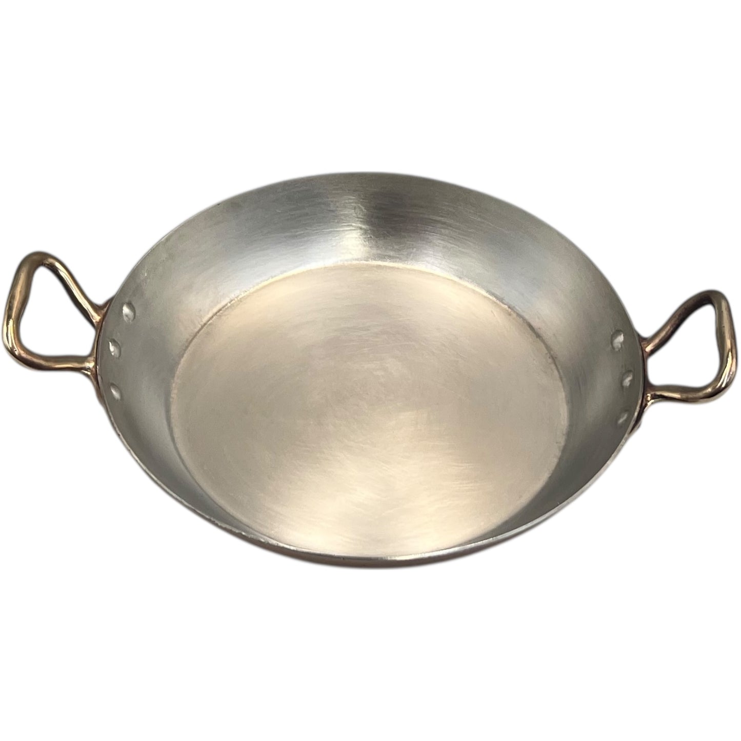 French copper round gratin pan with brass handles and hand wiped tin lining on a white background