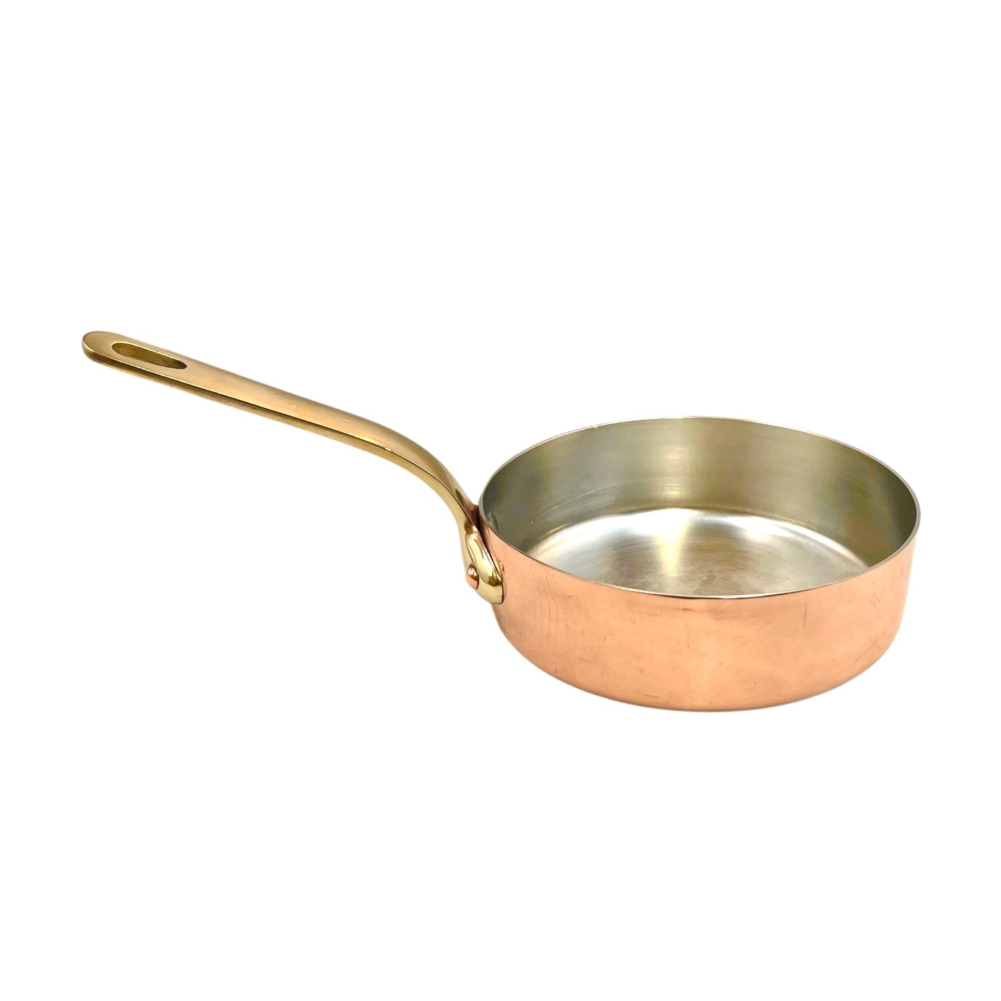 Copper frying pan with a brass handle on a white background