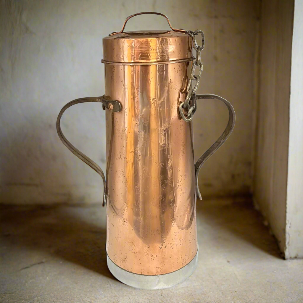 Copper vintage milk churn with handles on a neutral background