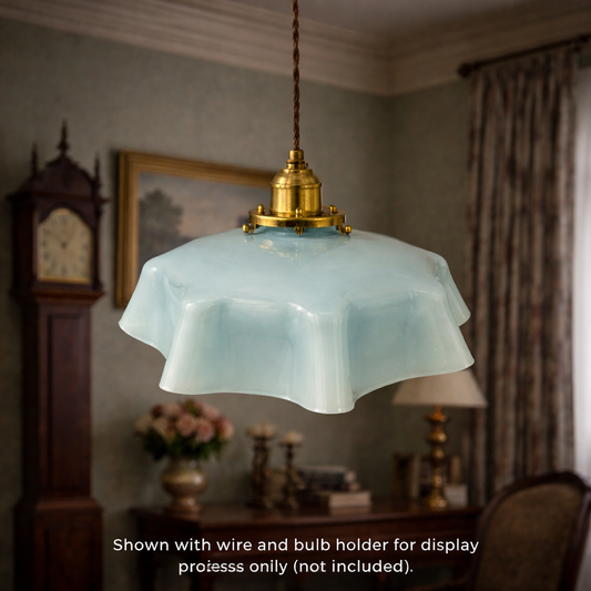 Vintage-style pendant light with a decorative shade in a room setting.