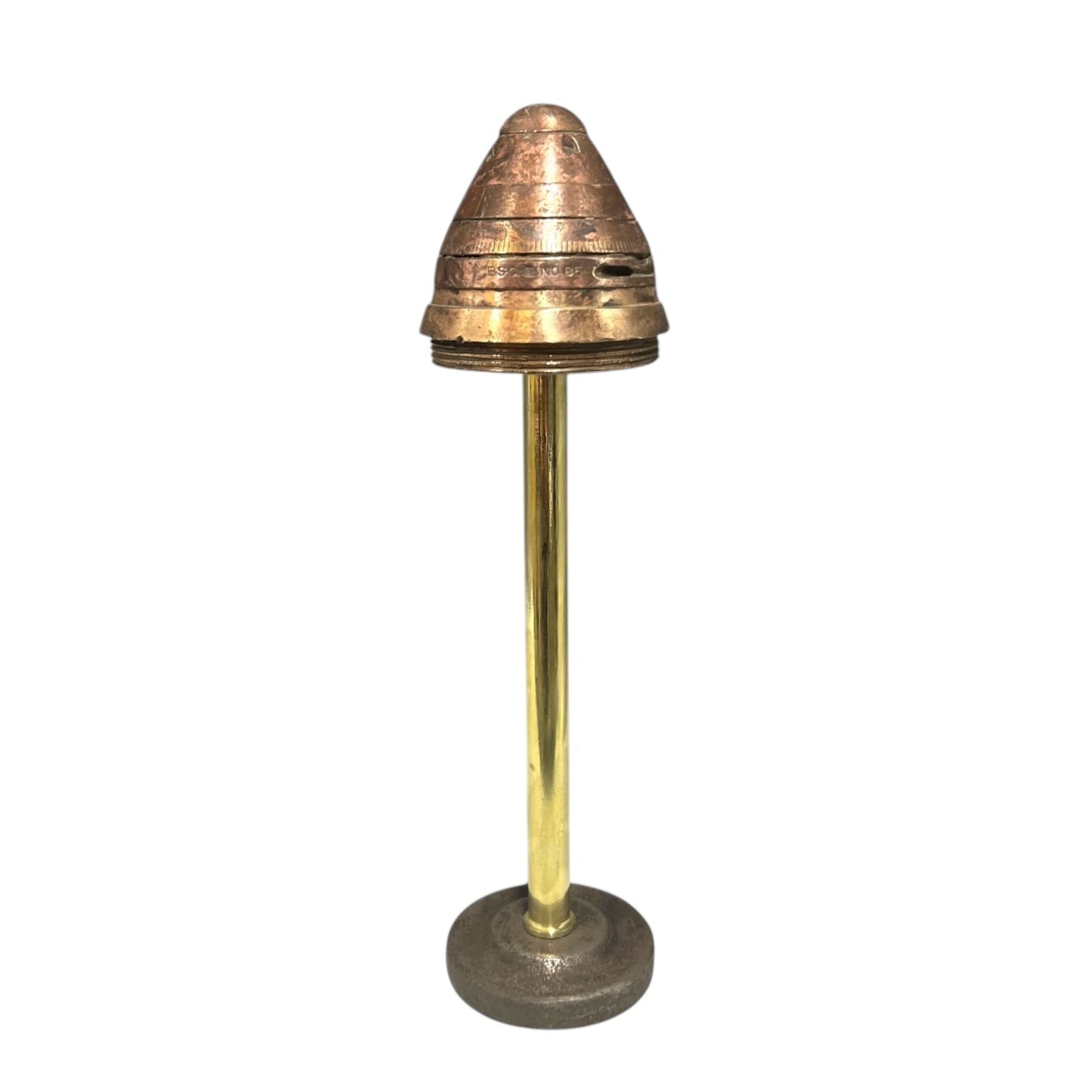 A WW1 British No. 85 brass fuse with internal pipe and base, displayed on a stand, showing signs of age and use for sale from All Things French Store.