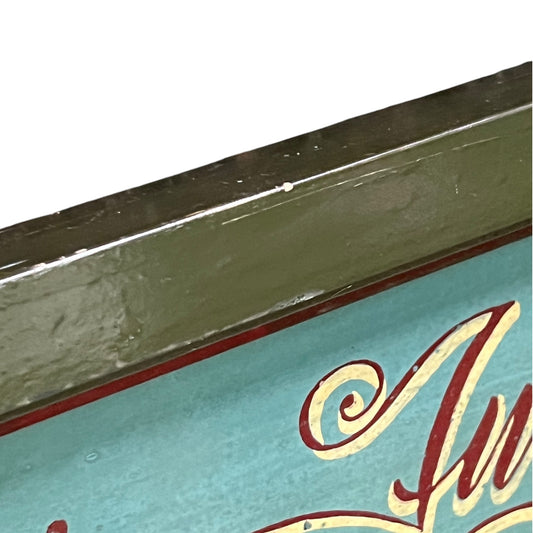 Close-up of a vintage-style sign with decorative text on a white background.