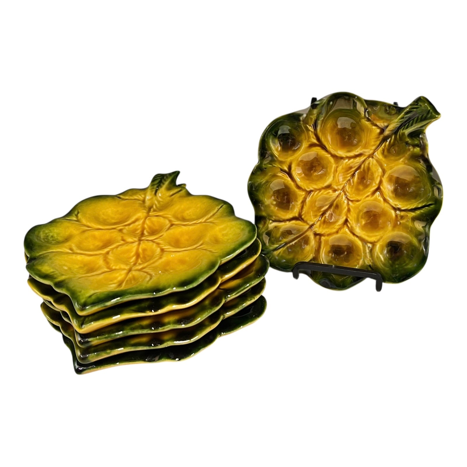 Set of green ceramic leaf-shaped snail escargots plates on a white background