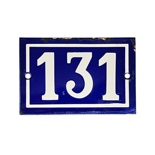 A rectangular blue house number plaque with white lettering reading '131' and a white border, shown on a plain white background.