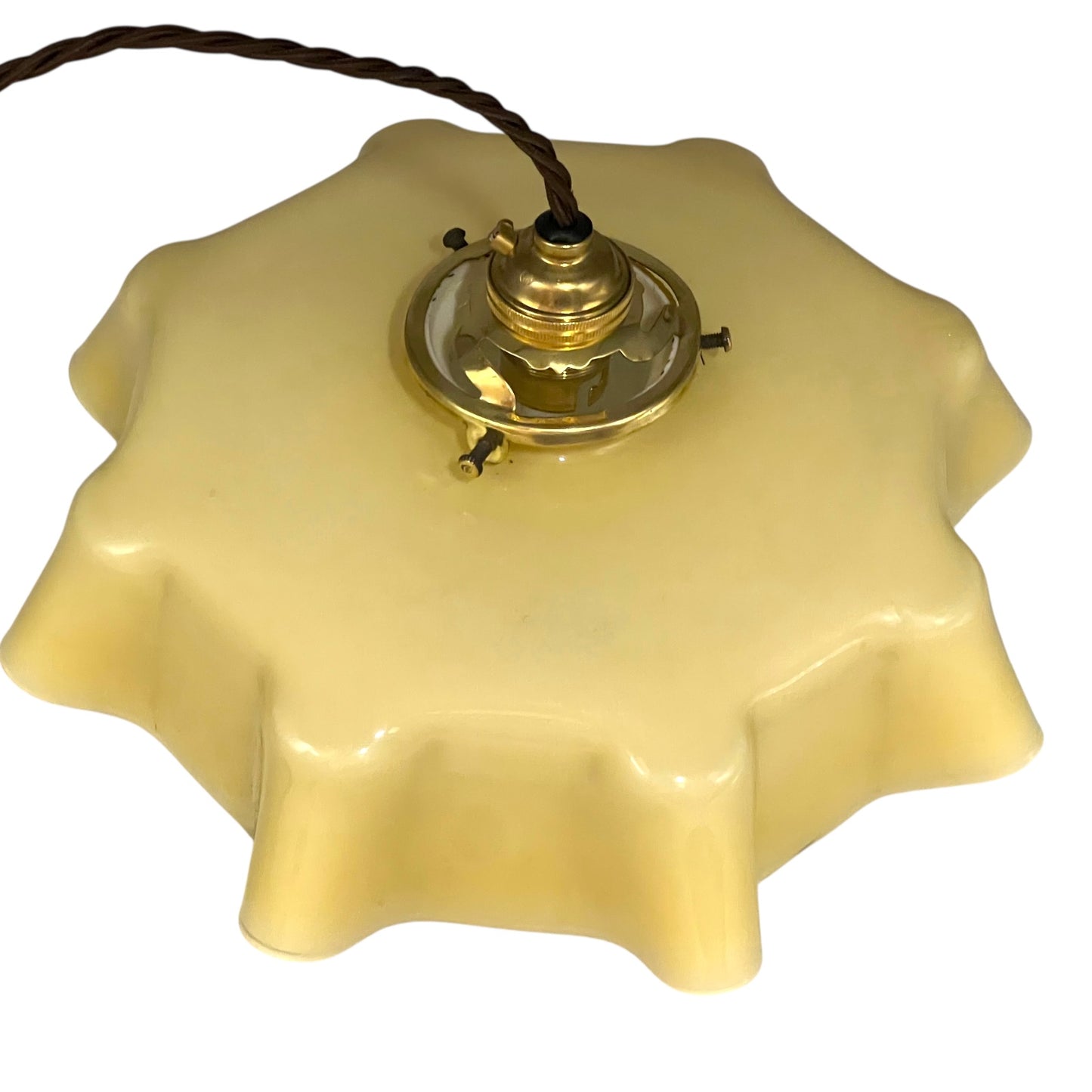Vintage-style pendant light with a yellow glass shade and brass fitting on a white background