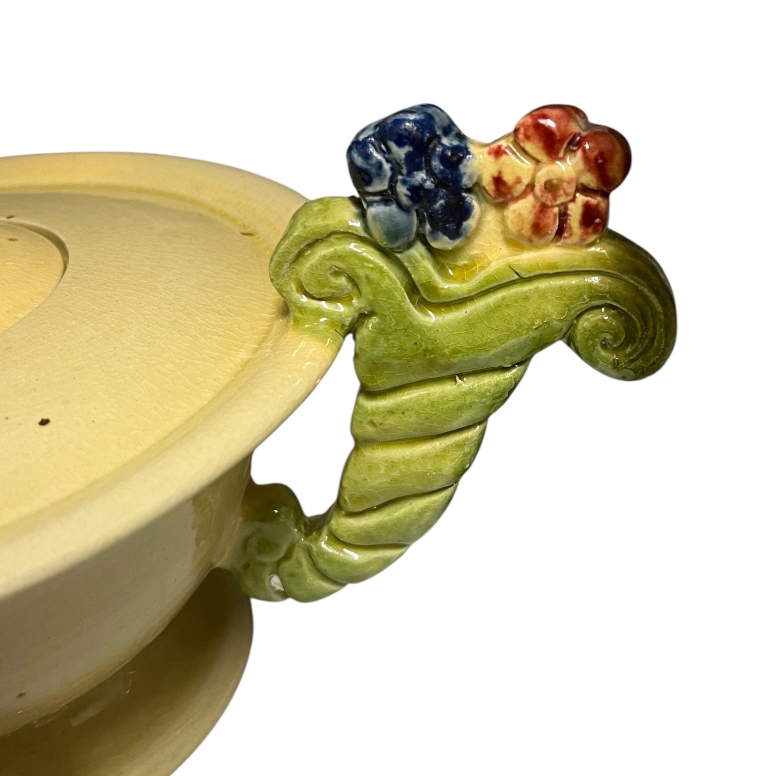 Stack of ceramic cups and plates with decorative handles on a white background