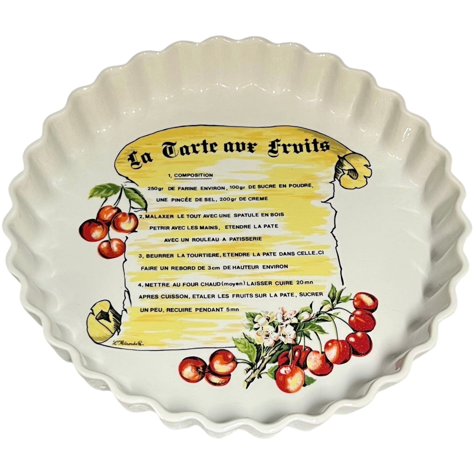 Decorative ceramic tart dish with fruit design and recipe text on a white background