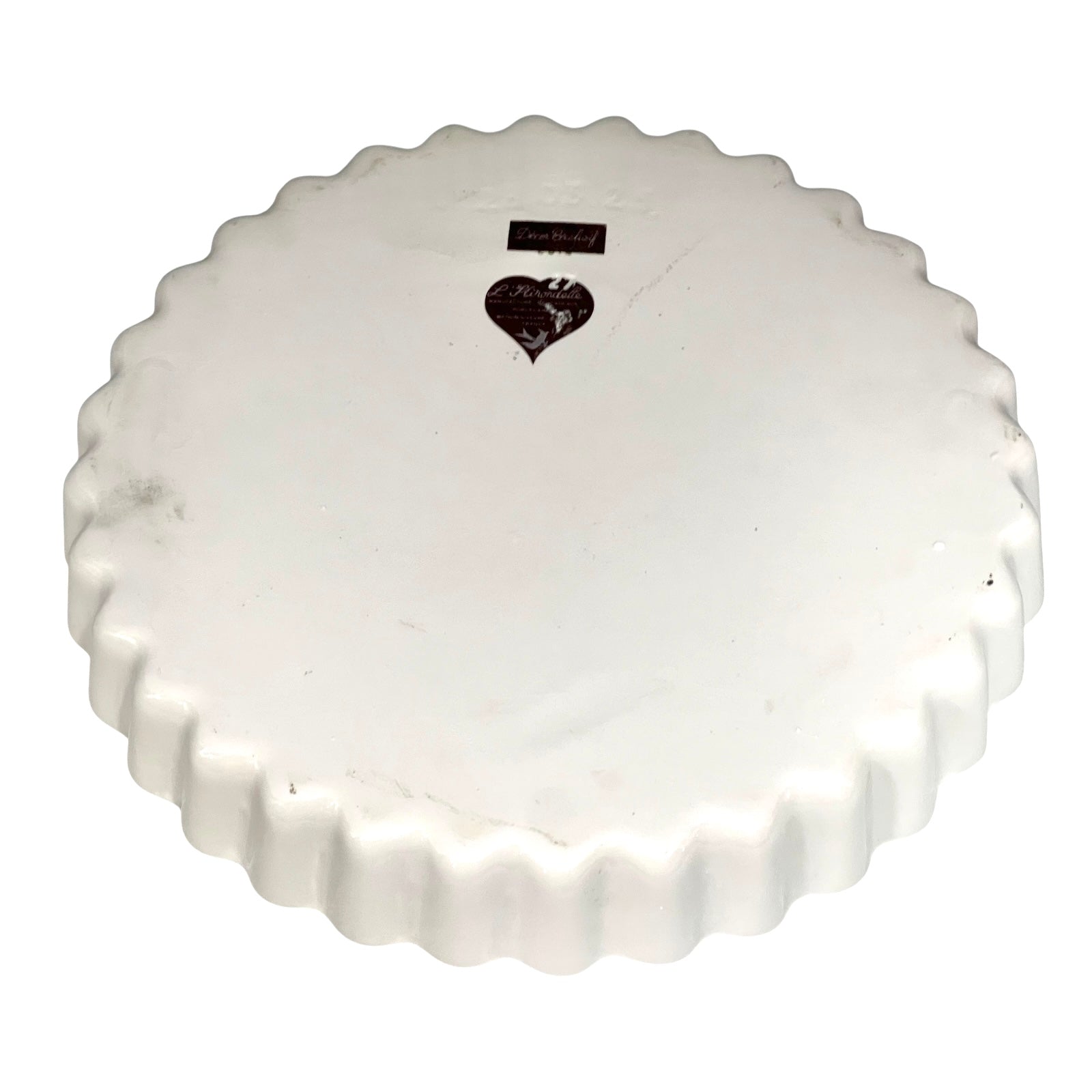 White ceramic pie dish with scalloped edge on a white background