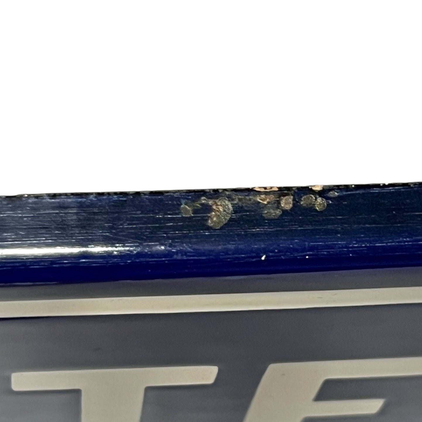 Close-up of a blue and white sign on a white background