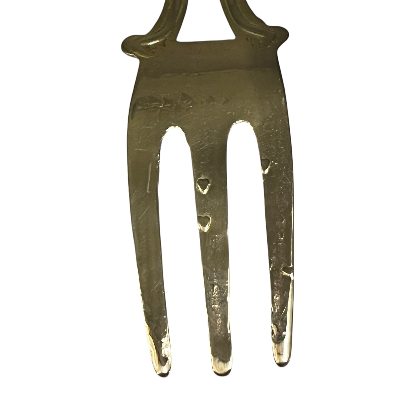Brass vintage fork on a white
background
