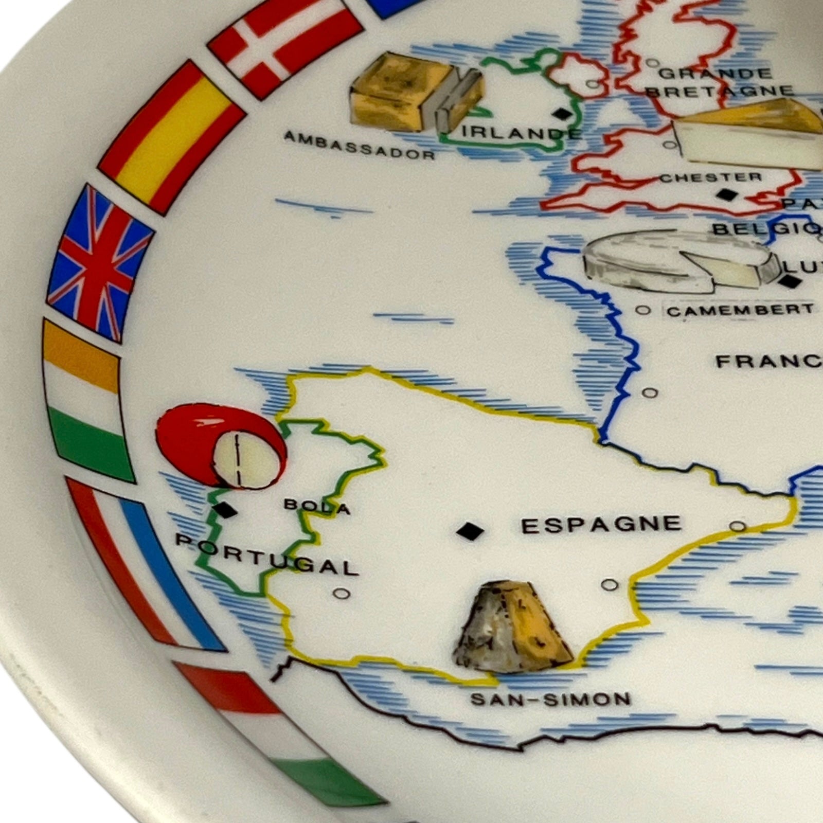 Map of Europe on a decorative cheeseboard with flags and geographical features.