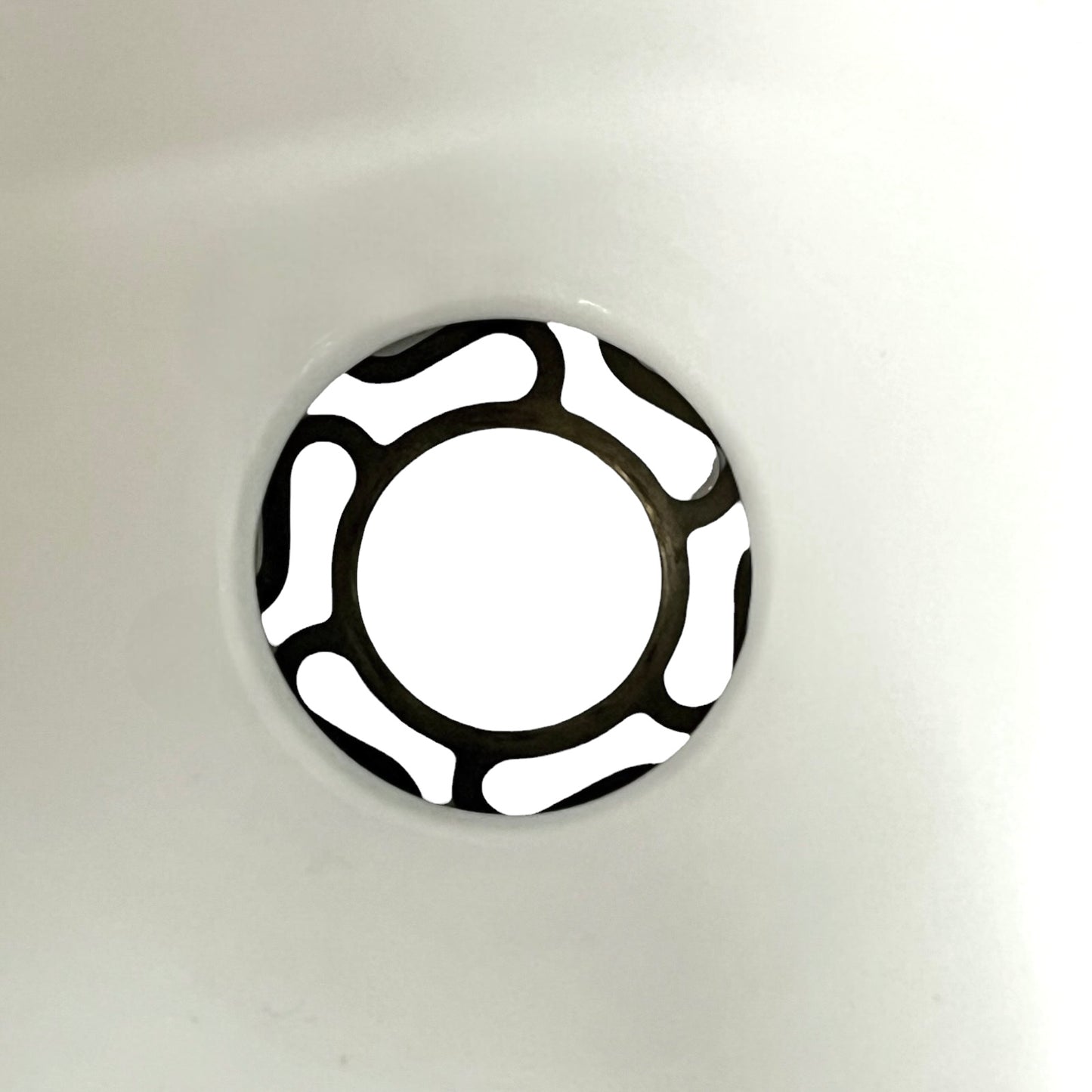 Close up of a white glass lamp shade with decorative design on a white background