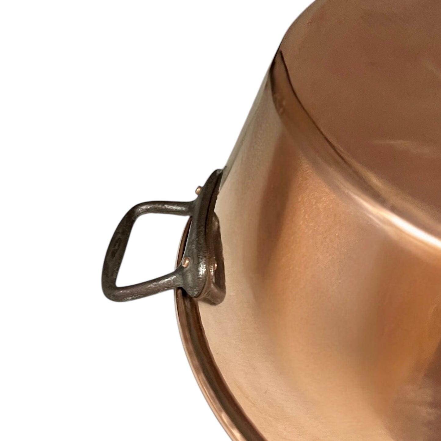 Close up of French copper bowl upcycled into a copper sink with cast iron handles on a white background