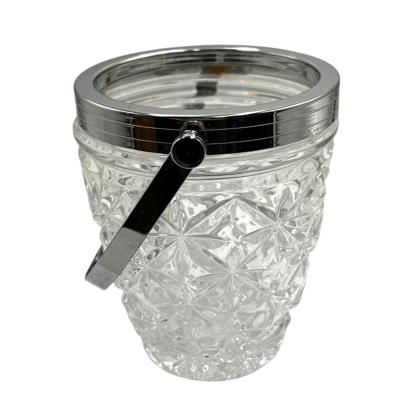 Clear French cut glass ice bucket with textured design and metal handle on a white background