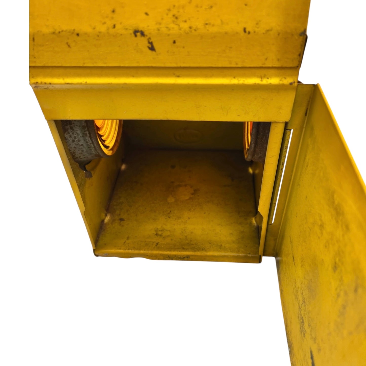 Close up of yellow vintage railway or railroad lamp with orange glass panels and a hook on a white background