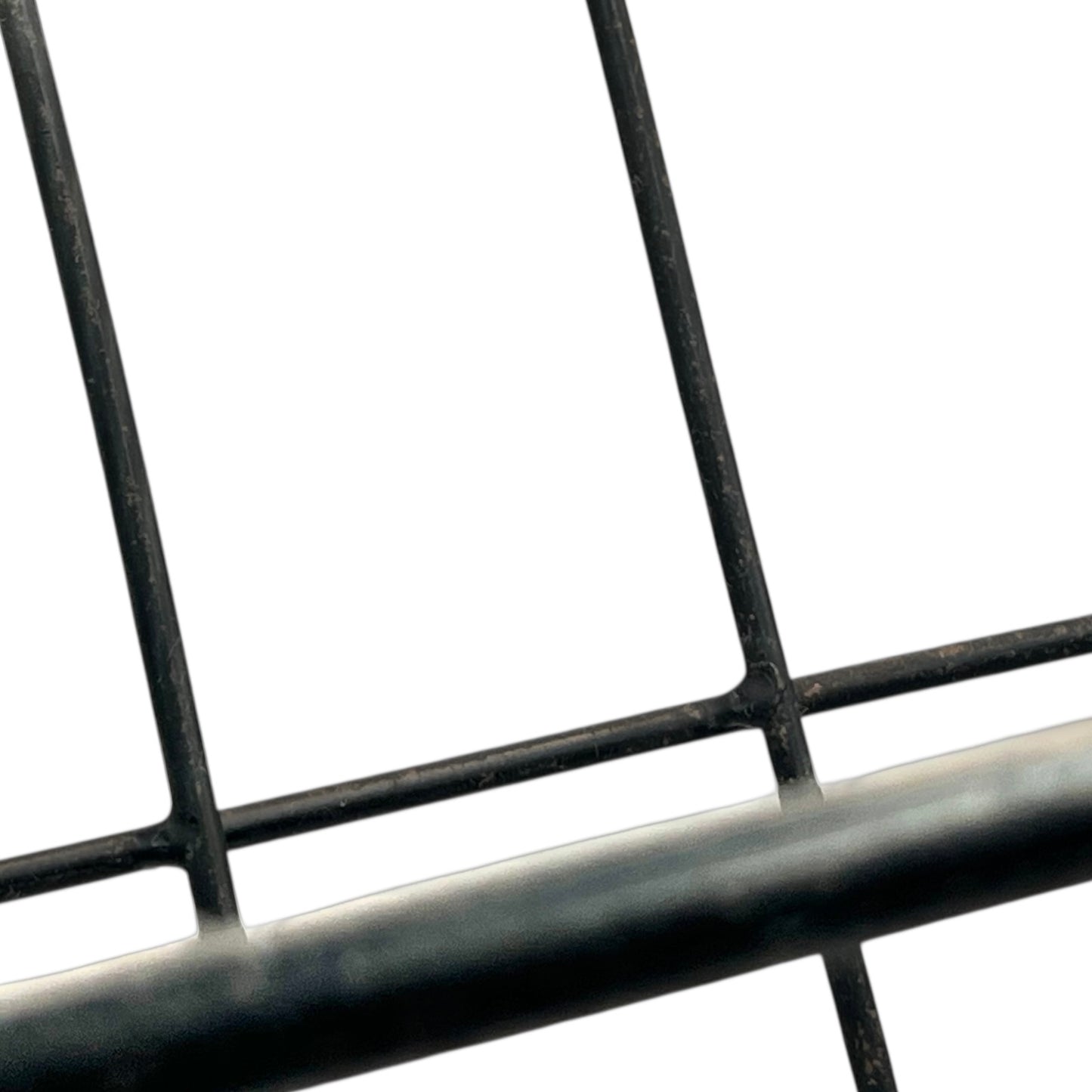 Close-up of a black metal stand on a white background