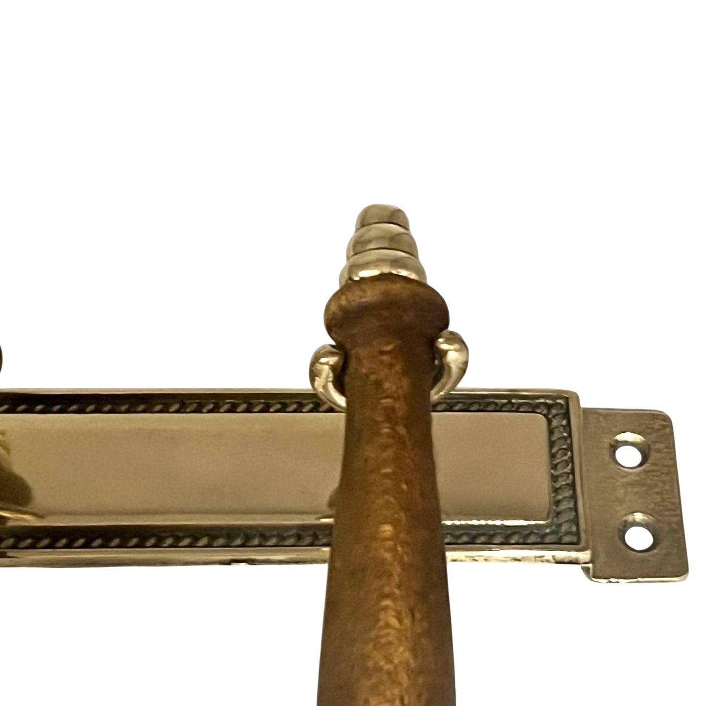Brass and wooden handle on a white background