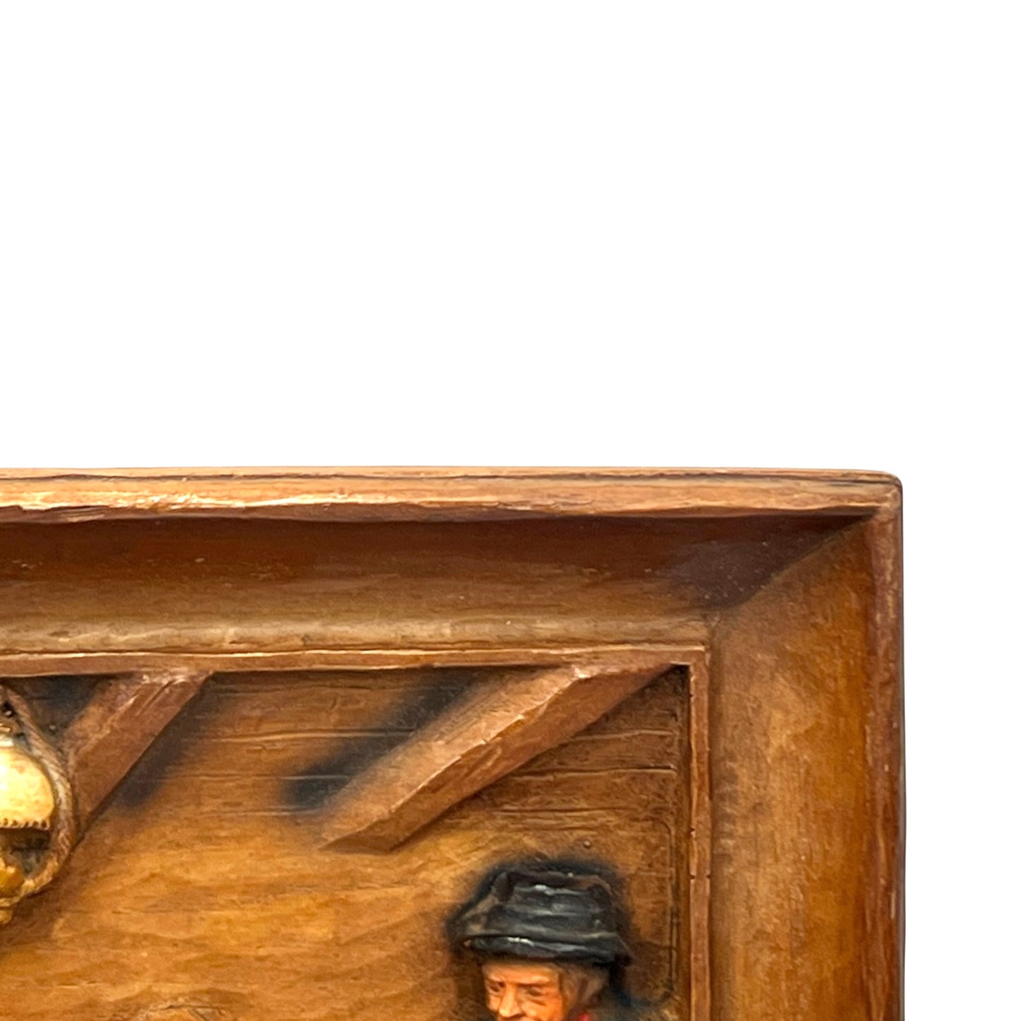 close up of wooden relief sculpture in an arts and crafts style on a white background