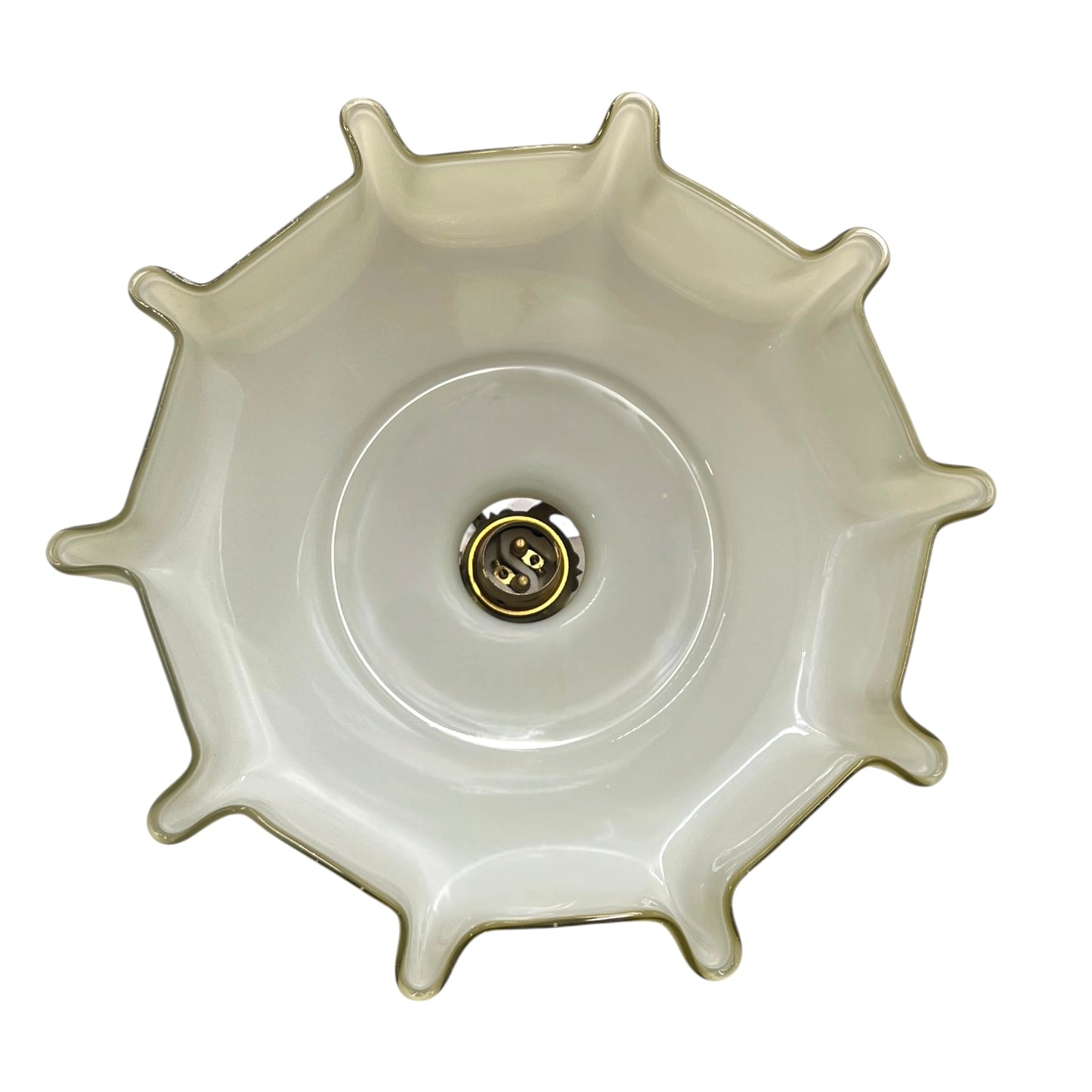 Close-up of a milk glass shade interior with a brass bulb holder on a white background