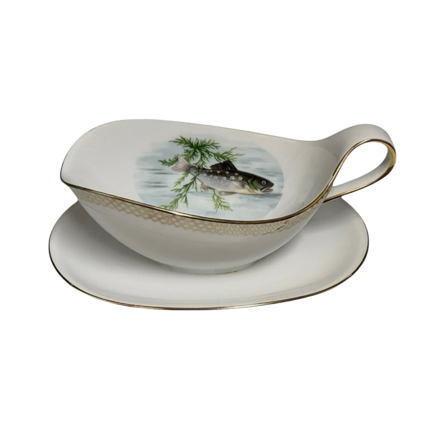 A French vintage porcelain gravy boat with a floral pattern and gold trim, featuring a traditional French fish design.