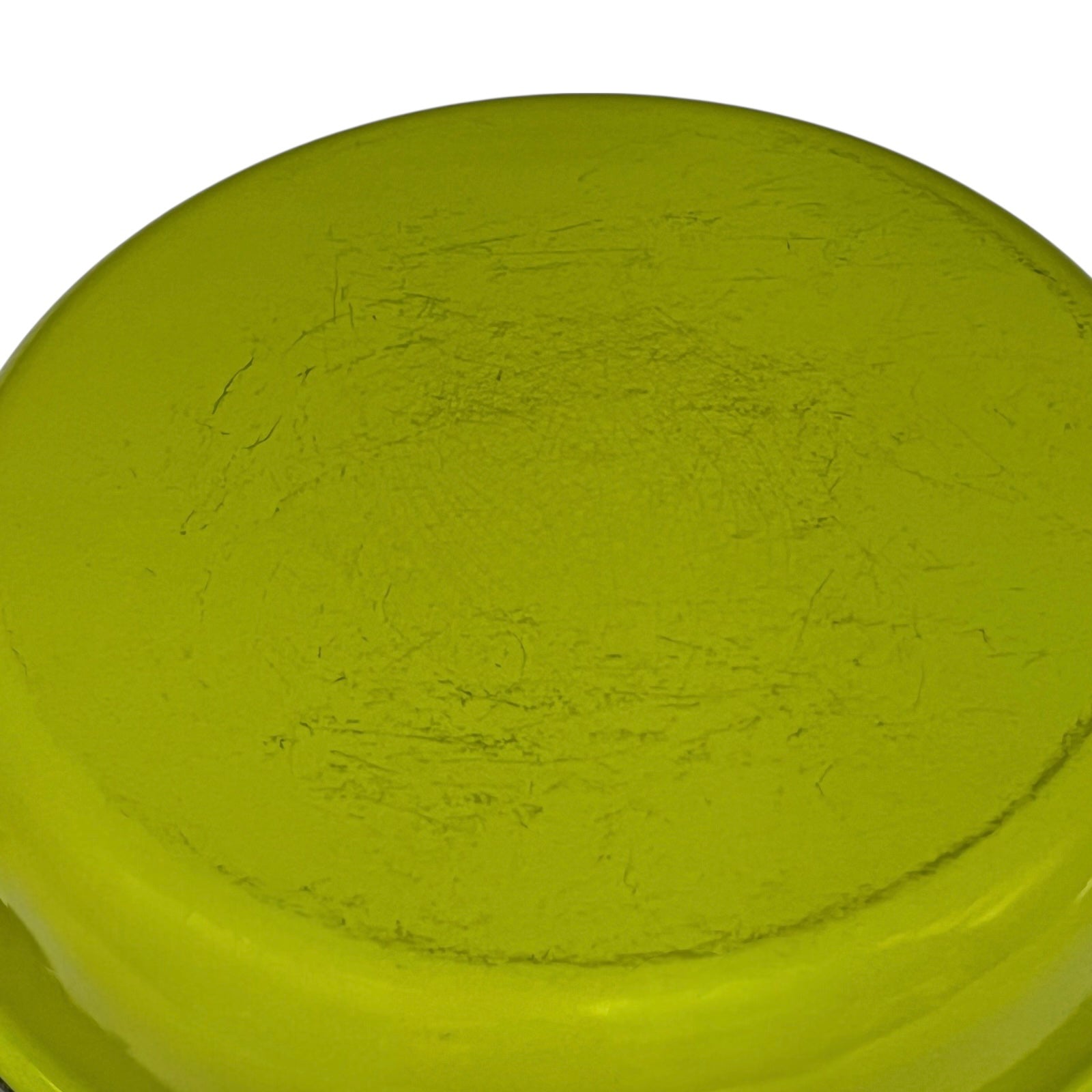 Green frying pan with a white interior on a white background