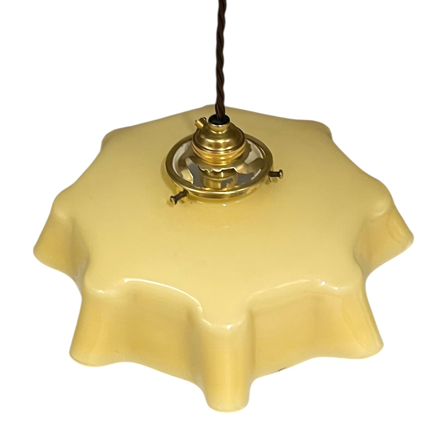 Vintage-style pendant light with a yellow glass shade and brass fitting on a white background