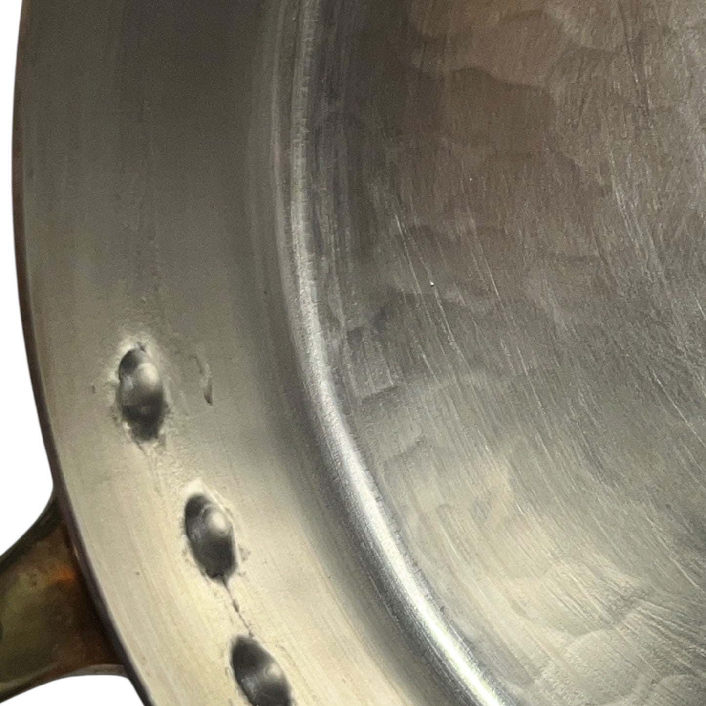 Close-up of a frying pan with tin lining on a white background