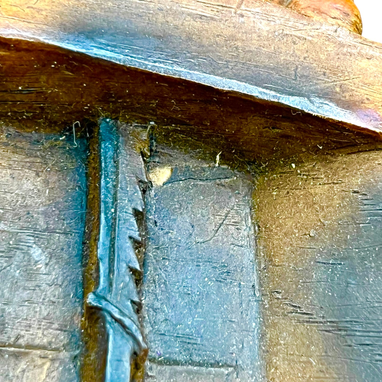 close up of wooden relief sculpture in an arts and crafts style on a white background