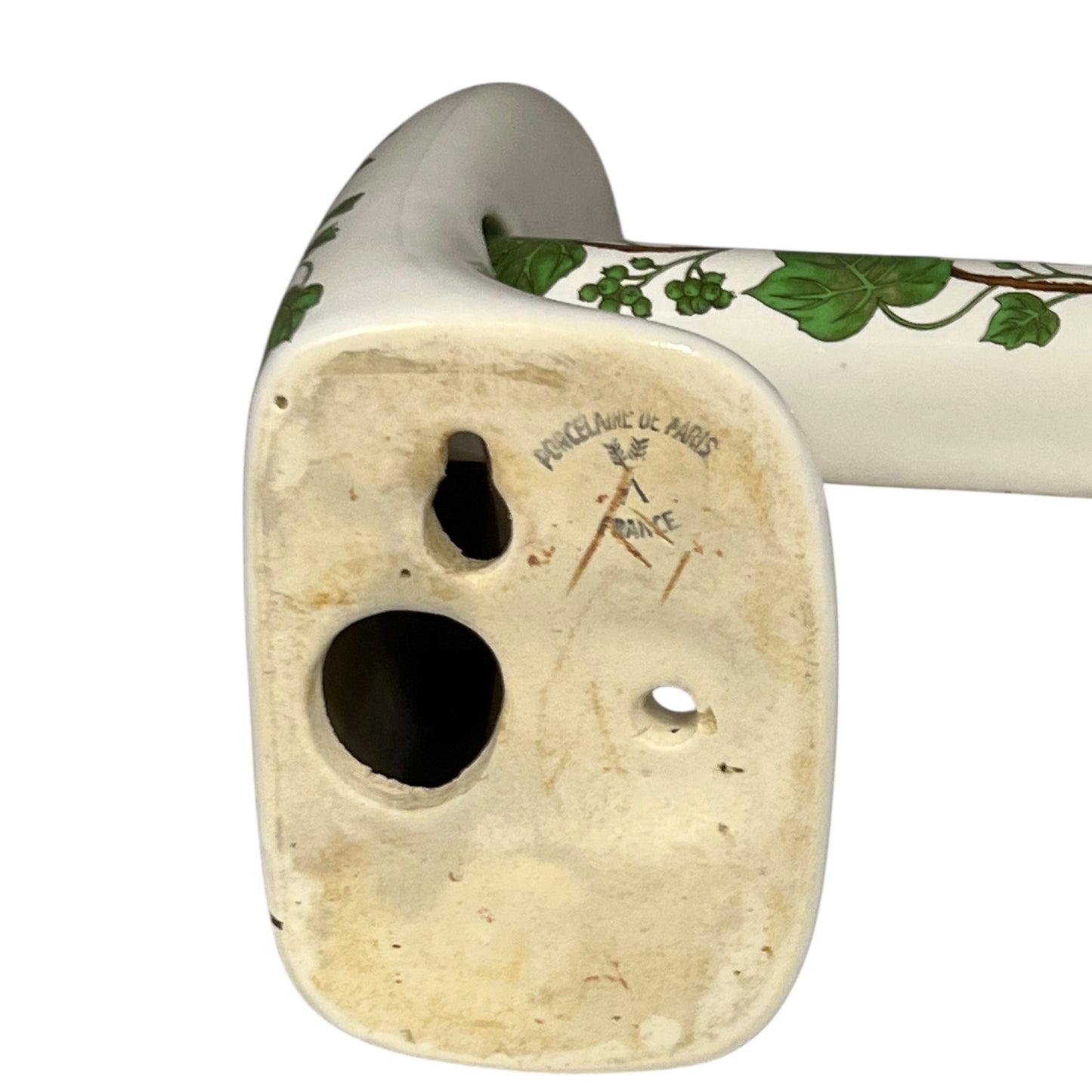 Ceramic bracket with leafdesign and 'Paris Porcelain' branding on a white background