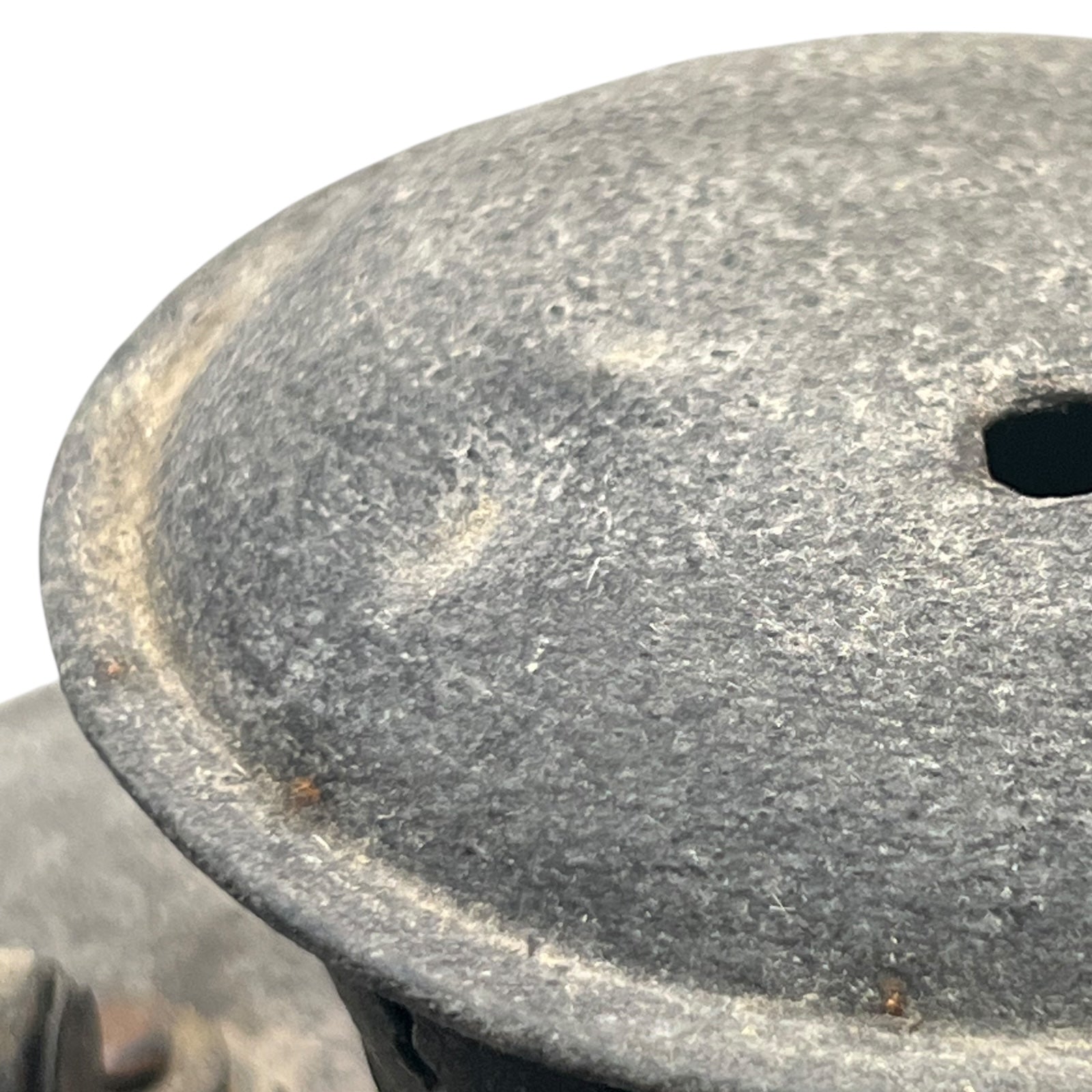 Close-up of a textured metal surface with a worn appearance