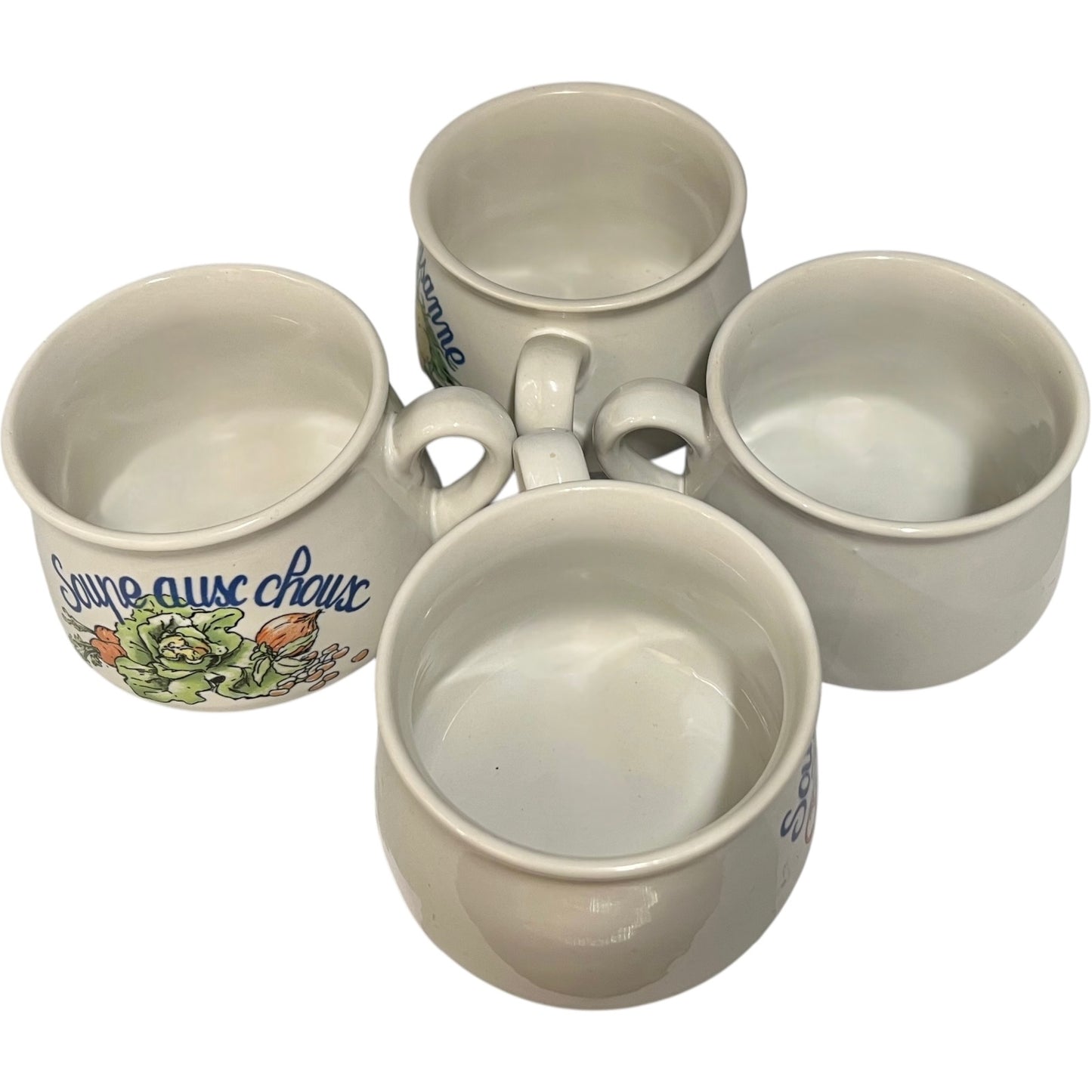 Set of four ceramic cups with soup design on a white background