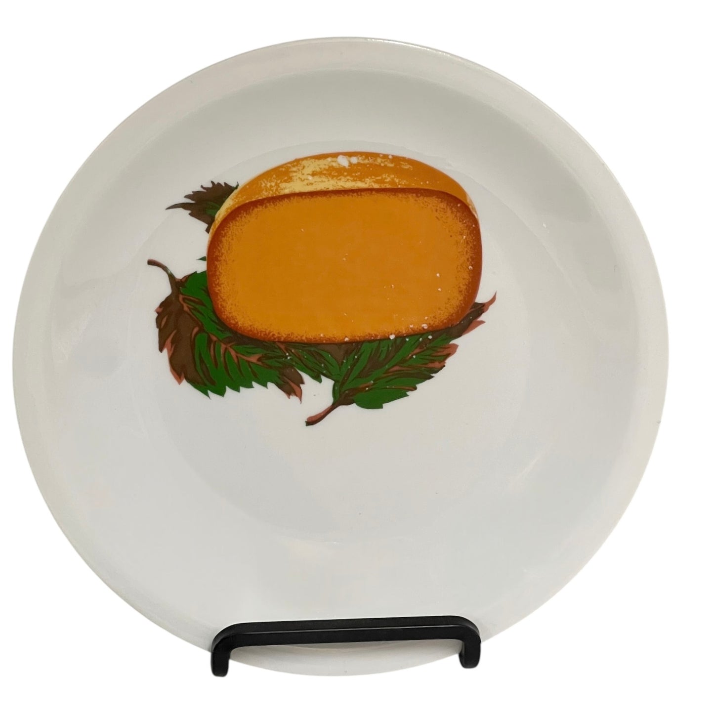 Round white plate with a cheese and leaf design on a stand