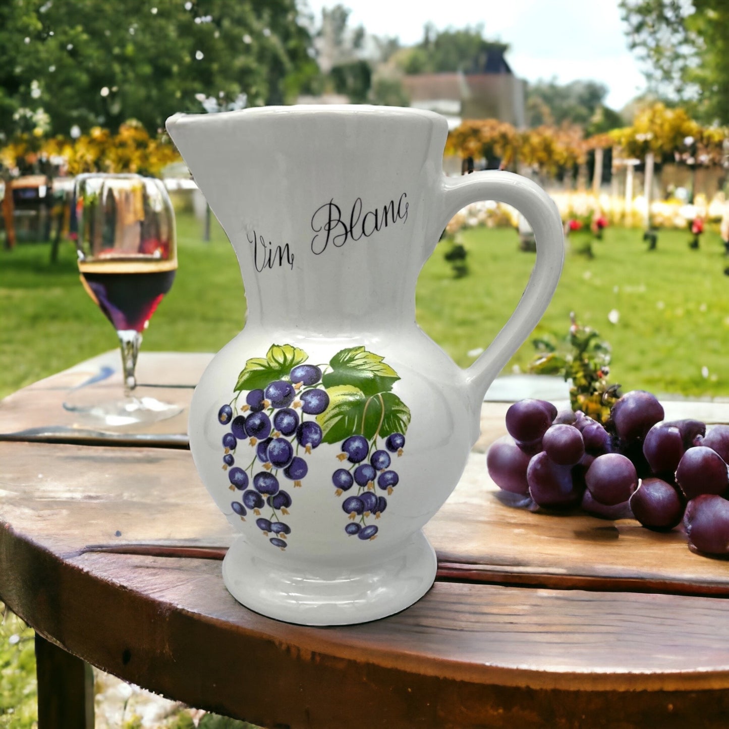 image French Revol porcelain white wine pitcher jug on a wooden table with grapes in a garden
