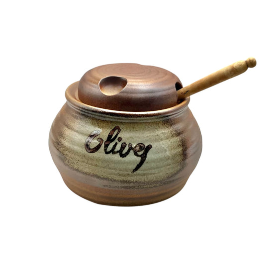 A brown stoneware ceramic olive pot with a wooden spoon, set against a white background, perfect for adding charm to a country cottage.