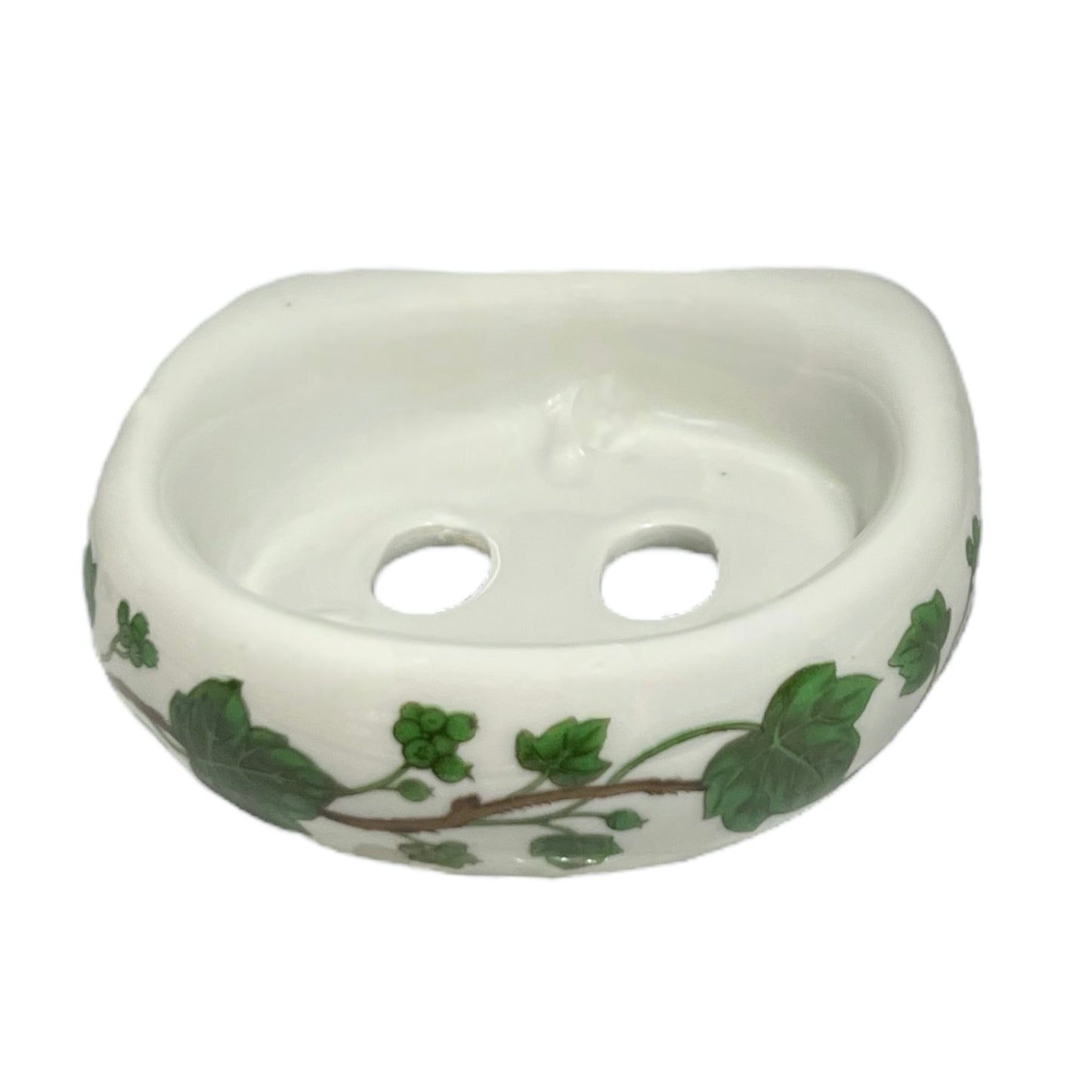 Porcelain bathroom toothbrush holder featuring green leaf patterns on a white background