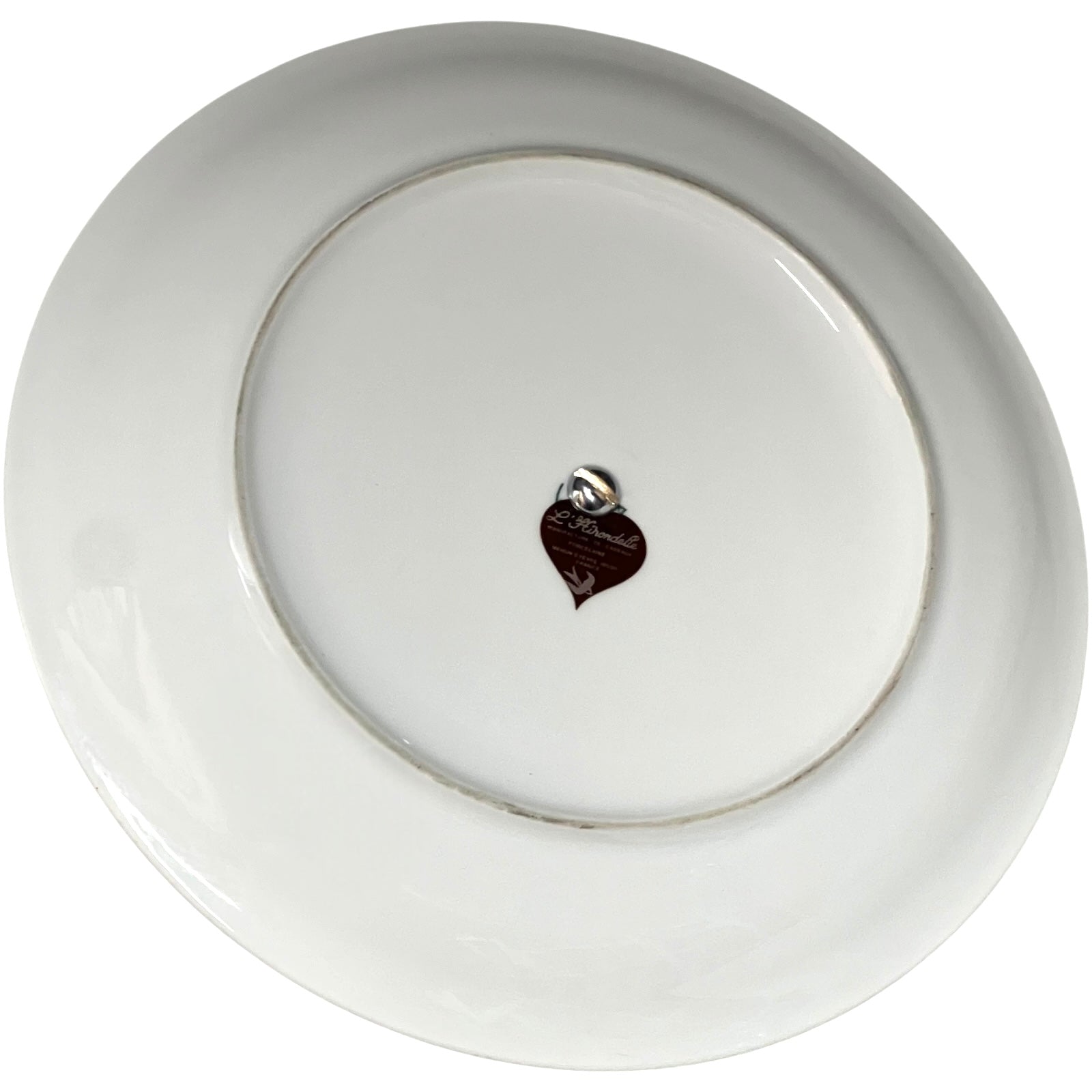 White ceramic cheeseboard with a decorative leaf-shaped item in the centre on a white background