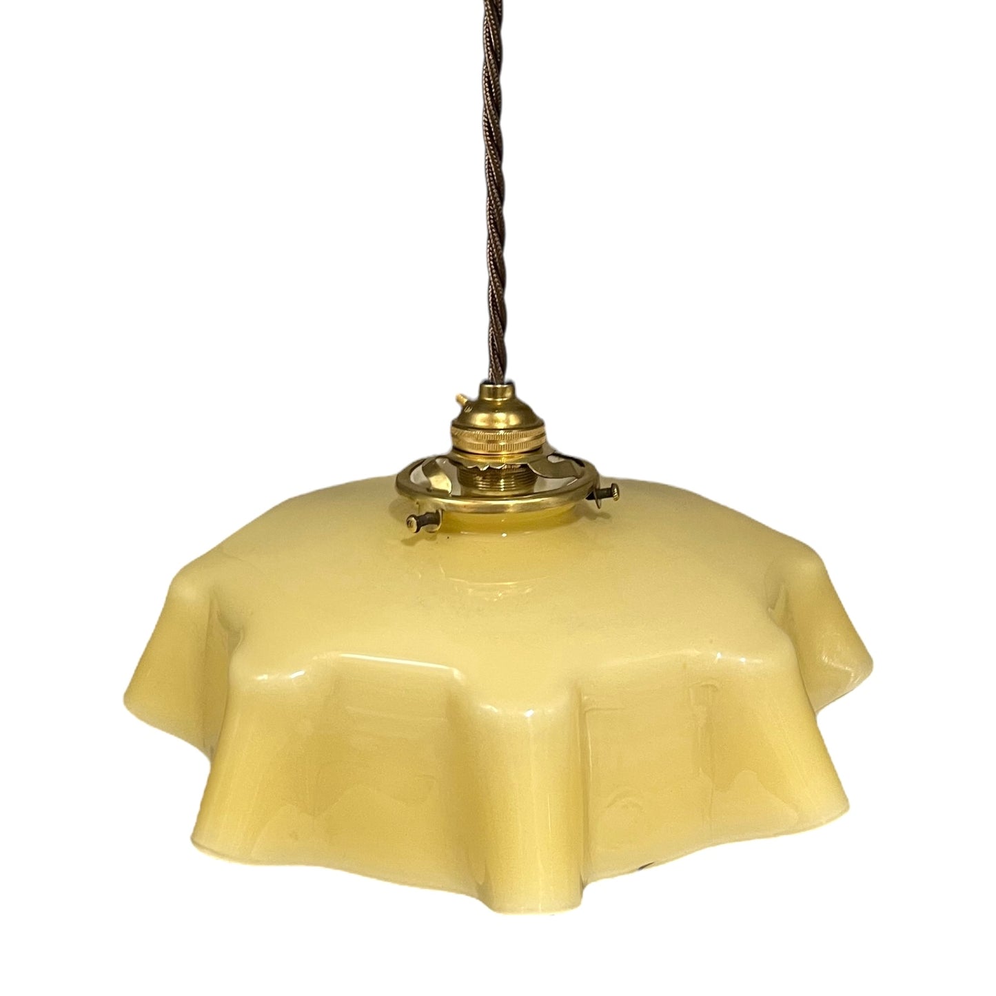 Vintage-style pendant light with a yellow glass shade and brass fitting on a white background