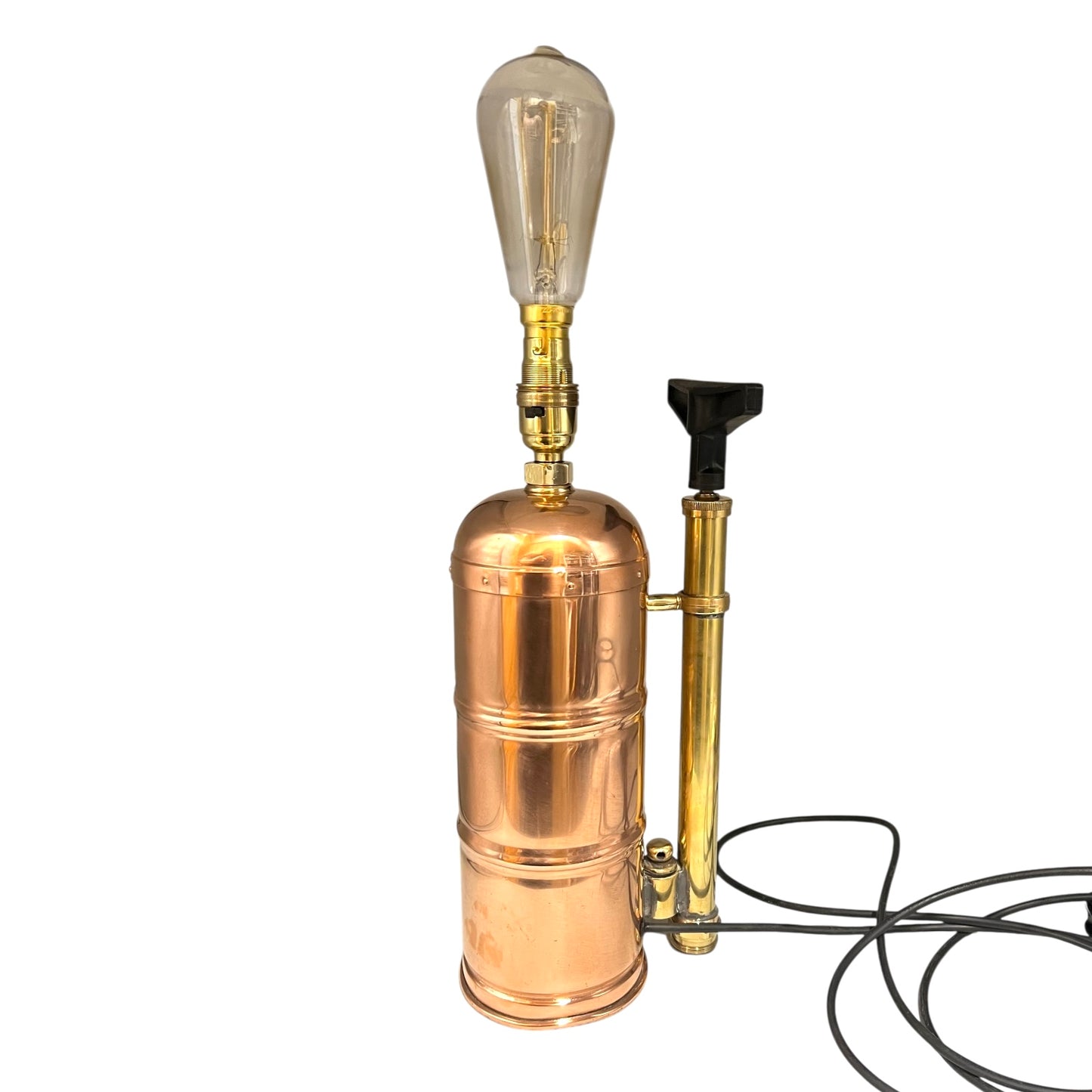 Copper and brass lamp with vintage-style light bulb on a white background