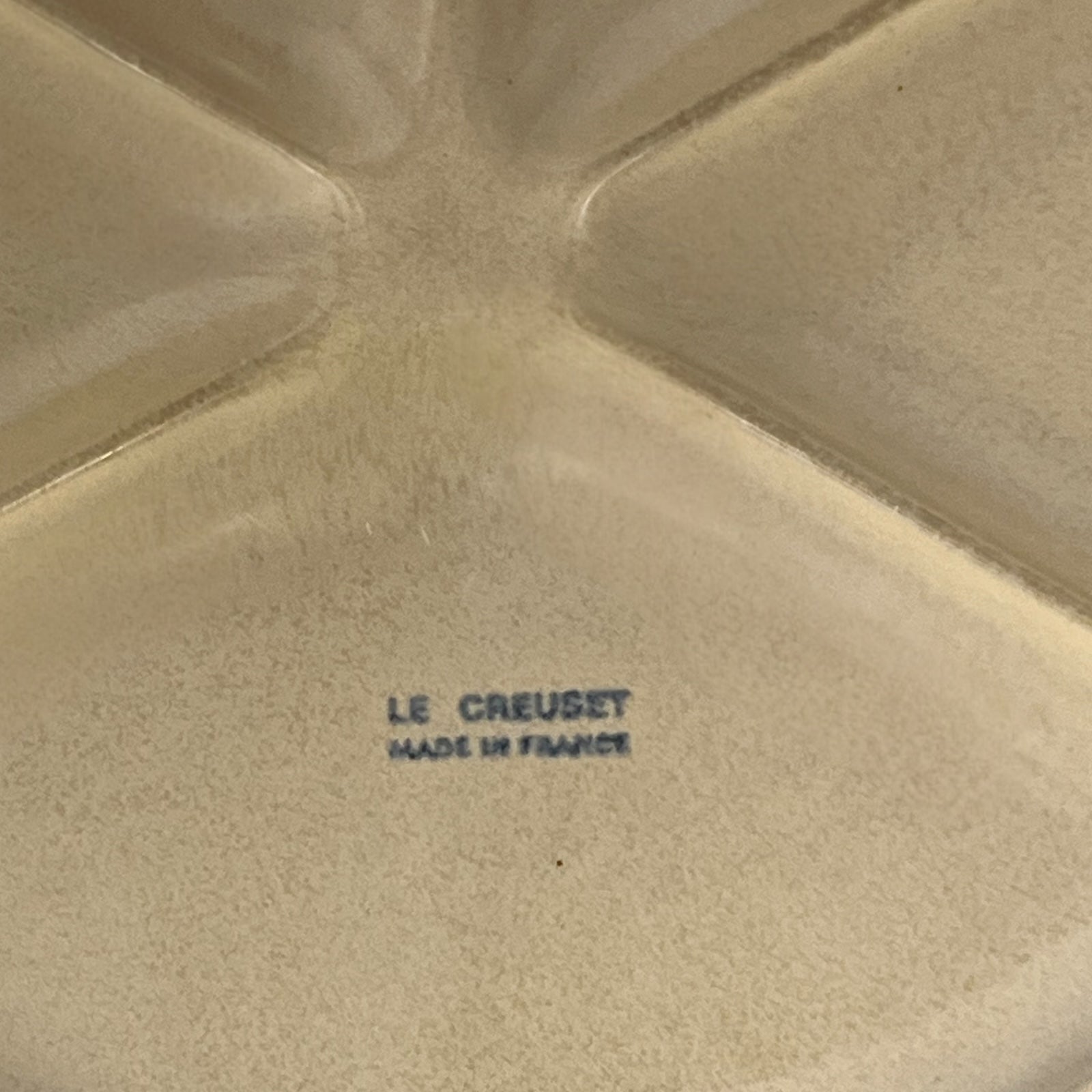 Le Creuset stamp on the back of a  plate