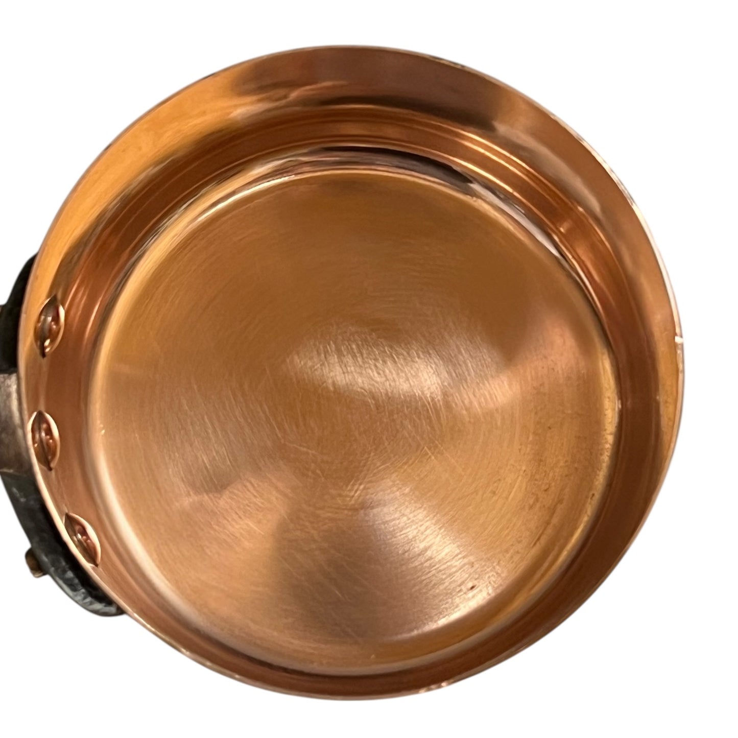 Close-up of a copper pot with a metal handle on a white background