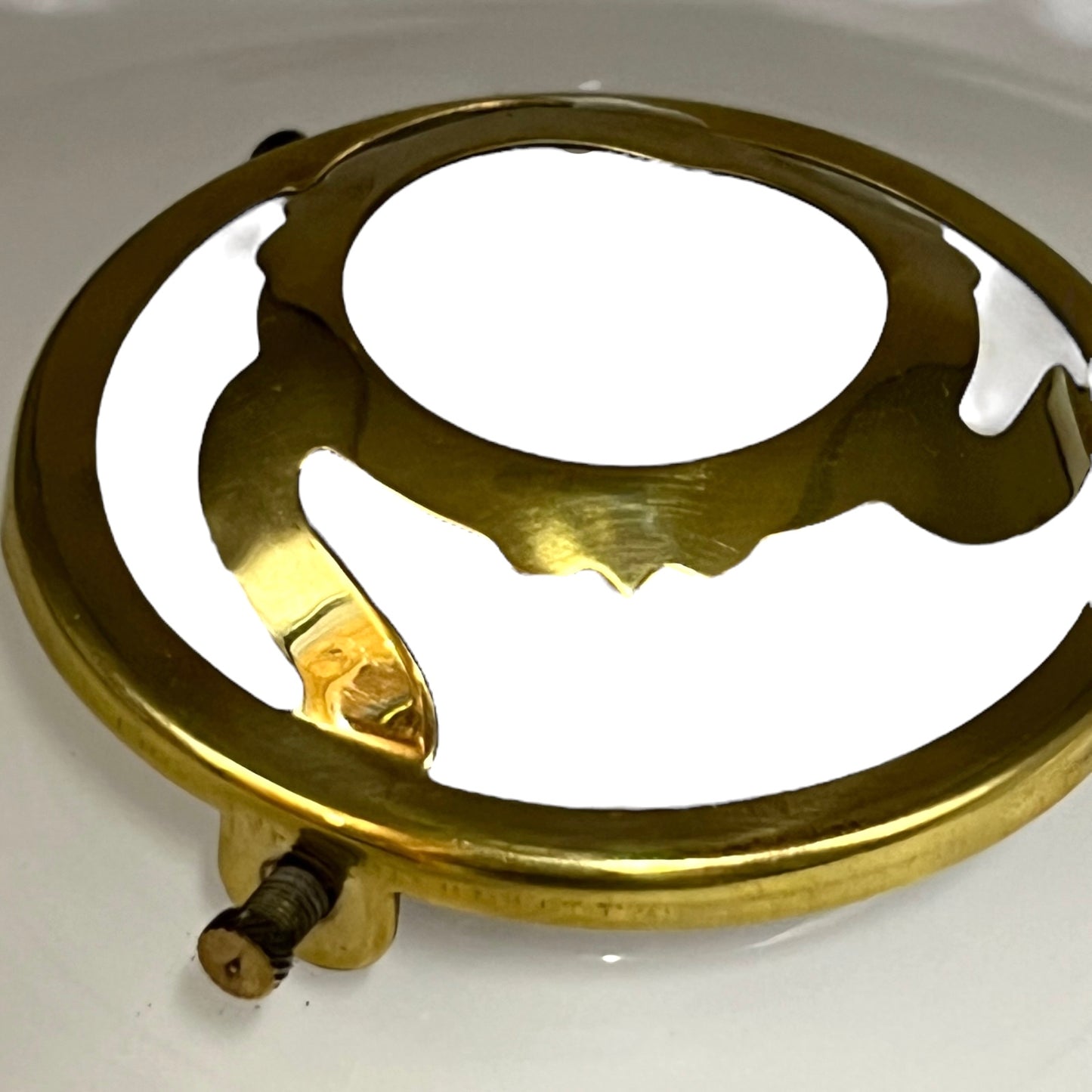 Brass light fitting on a white background