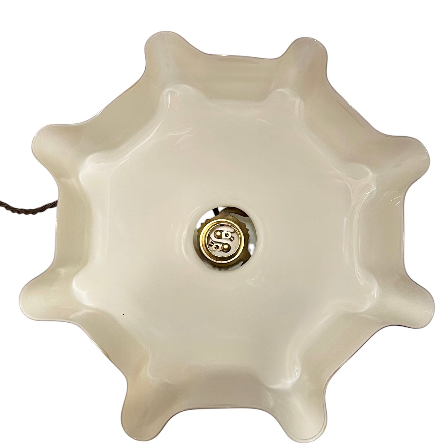 close up inside view of Vintage-style pendant light with a yellow glass shade and brass fitting on a white background