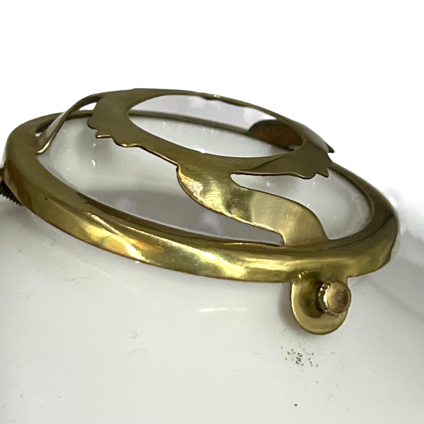 Brass lampshade gallery on a white surface