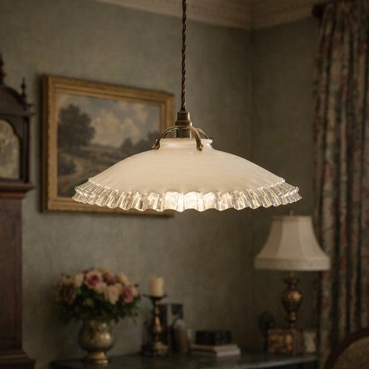 Vintage-style pendant light hanging in a room with decorative elements.