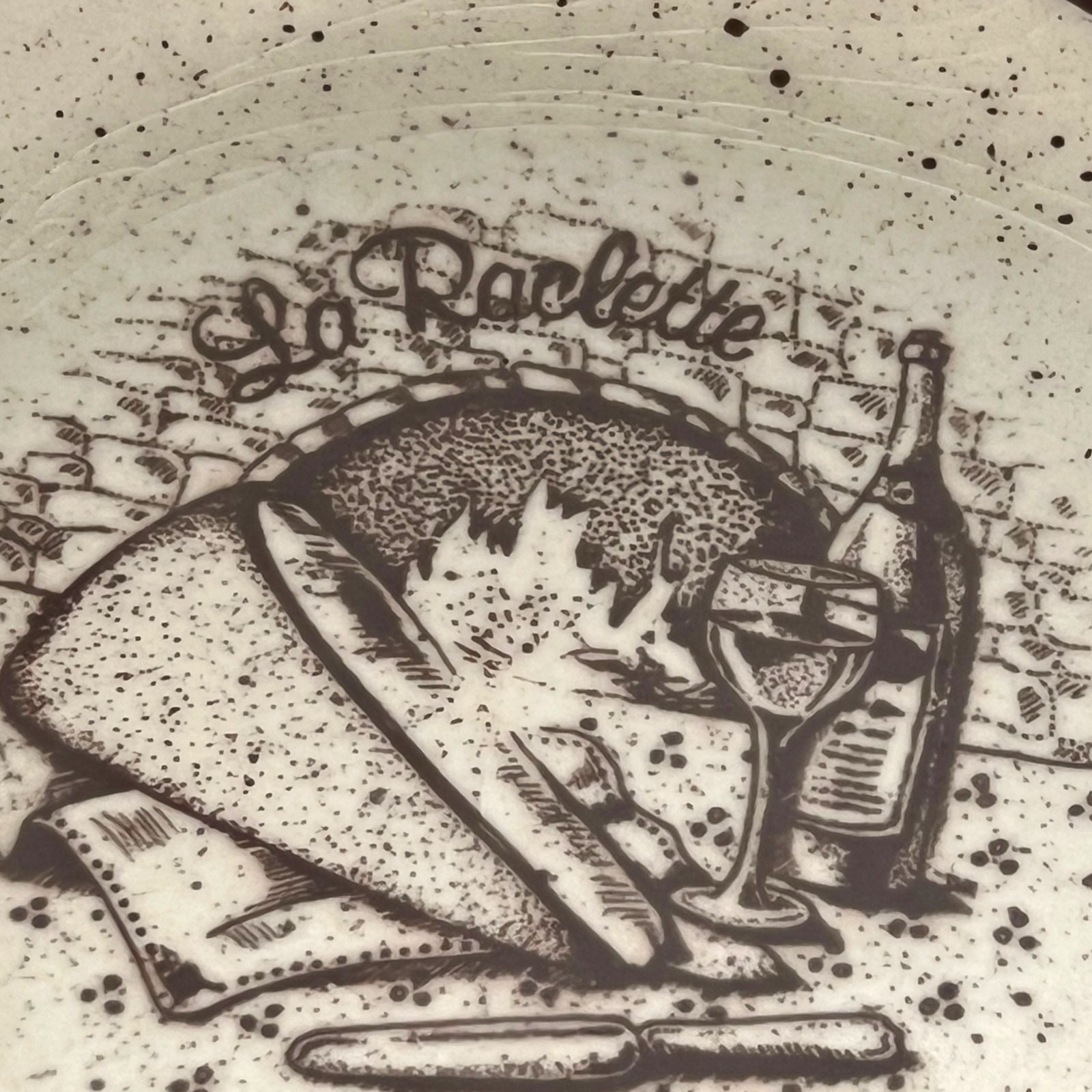 La Raclette plates with a decorative design on a white background