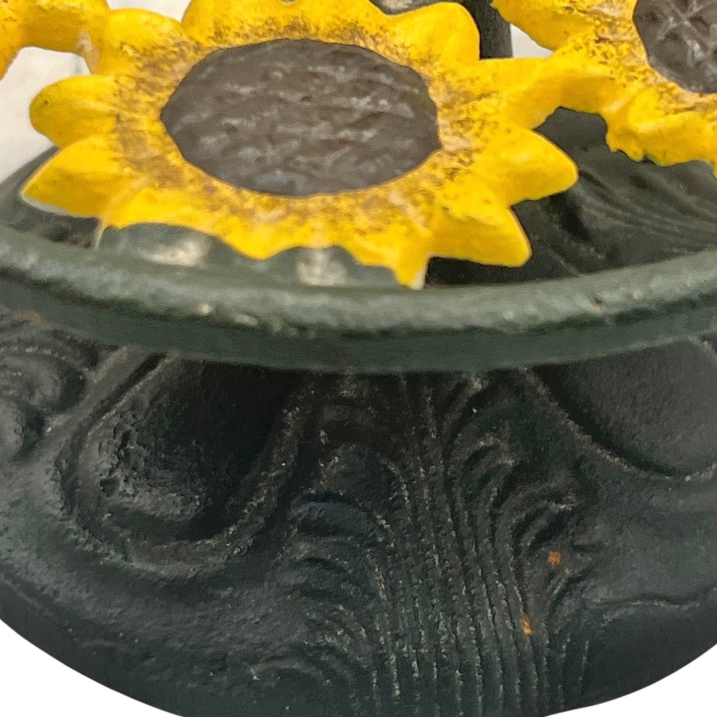 Decorative rustic paper towel holder with yellow sunflower designs on a black background