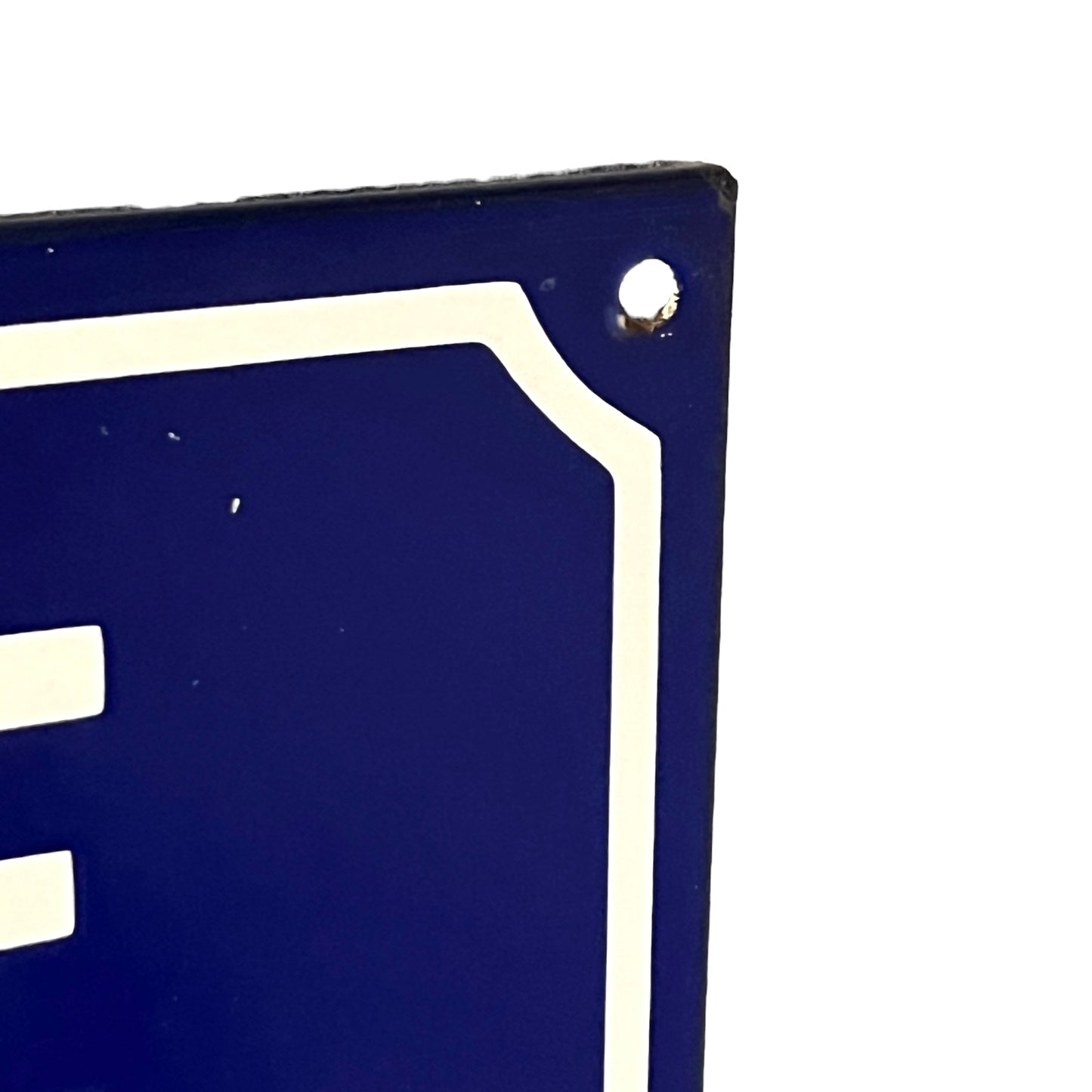 Close-up of a blue and white sign on a white background