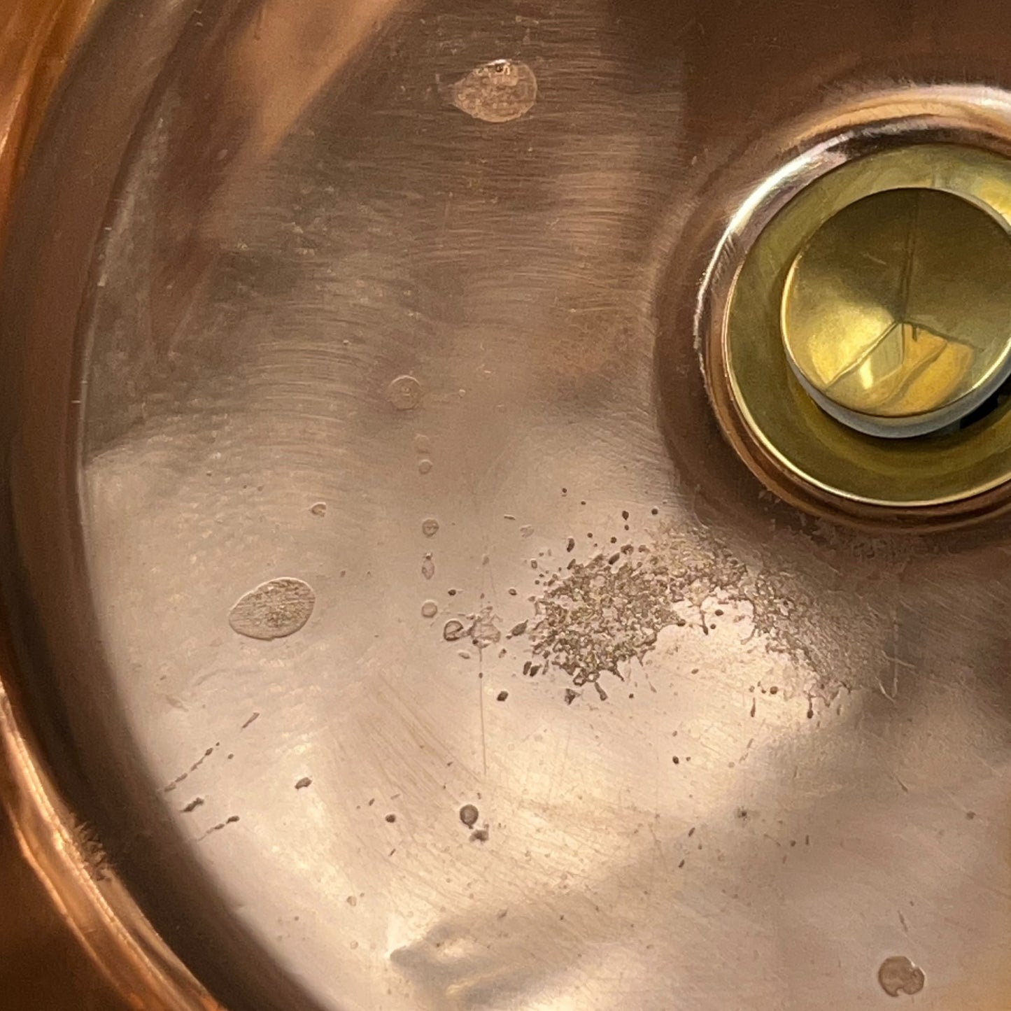 Close up of a copper basin sink on a white background