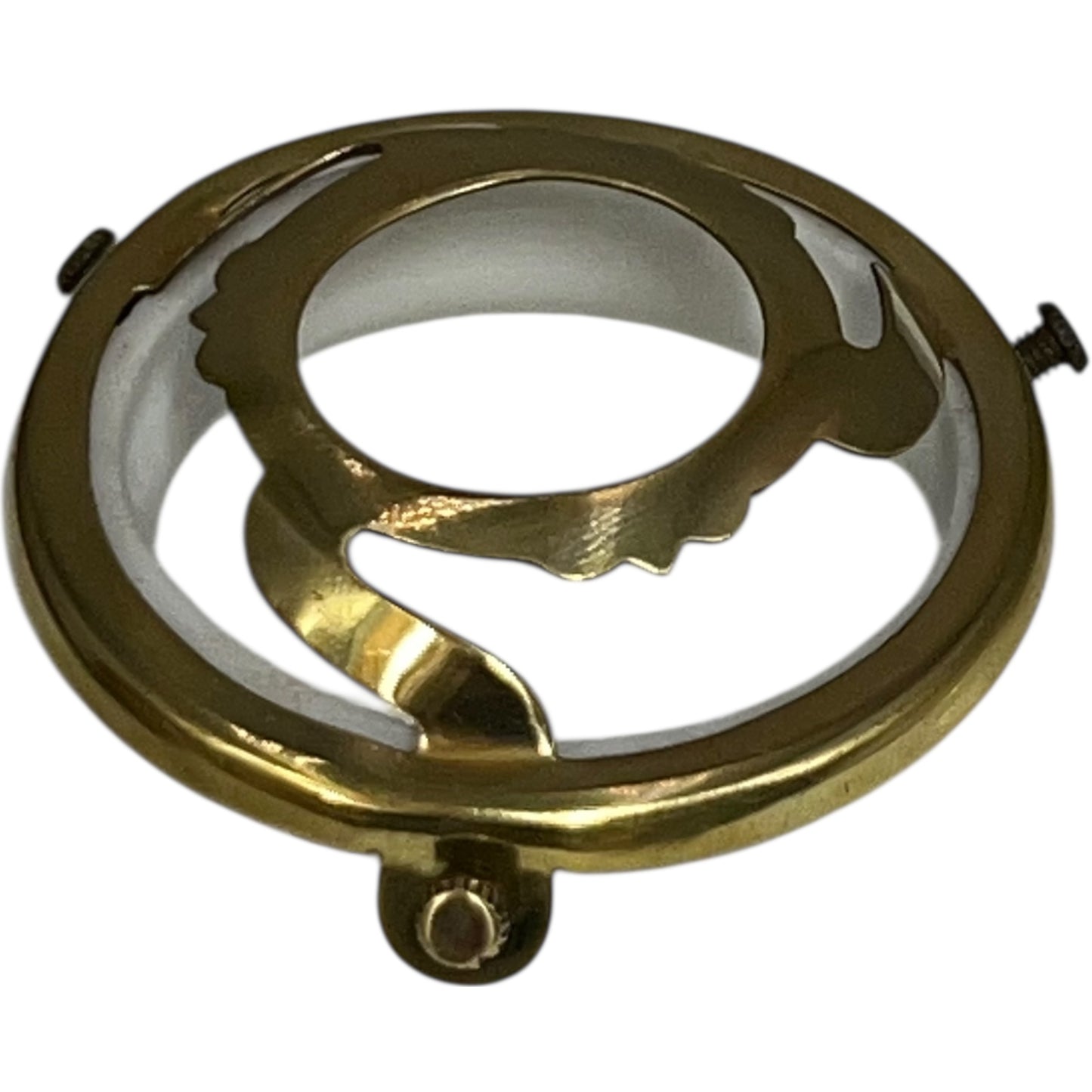 Gold metal ring with intricate design on a white background