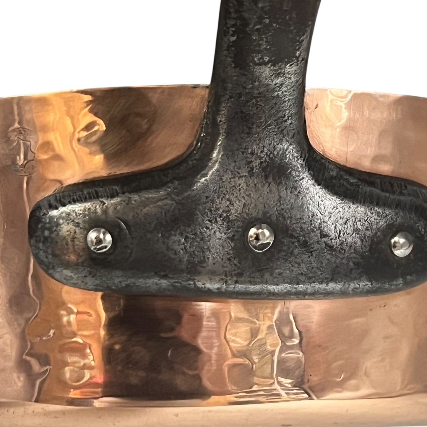 close up image of copper pan handle